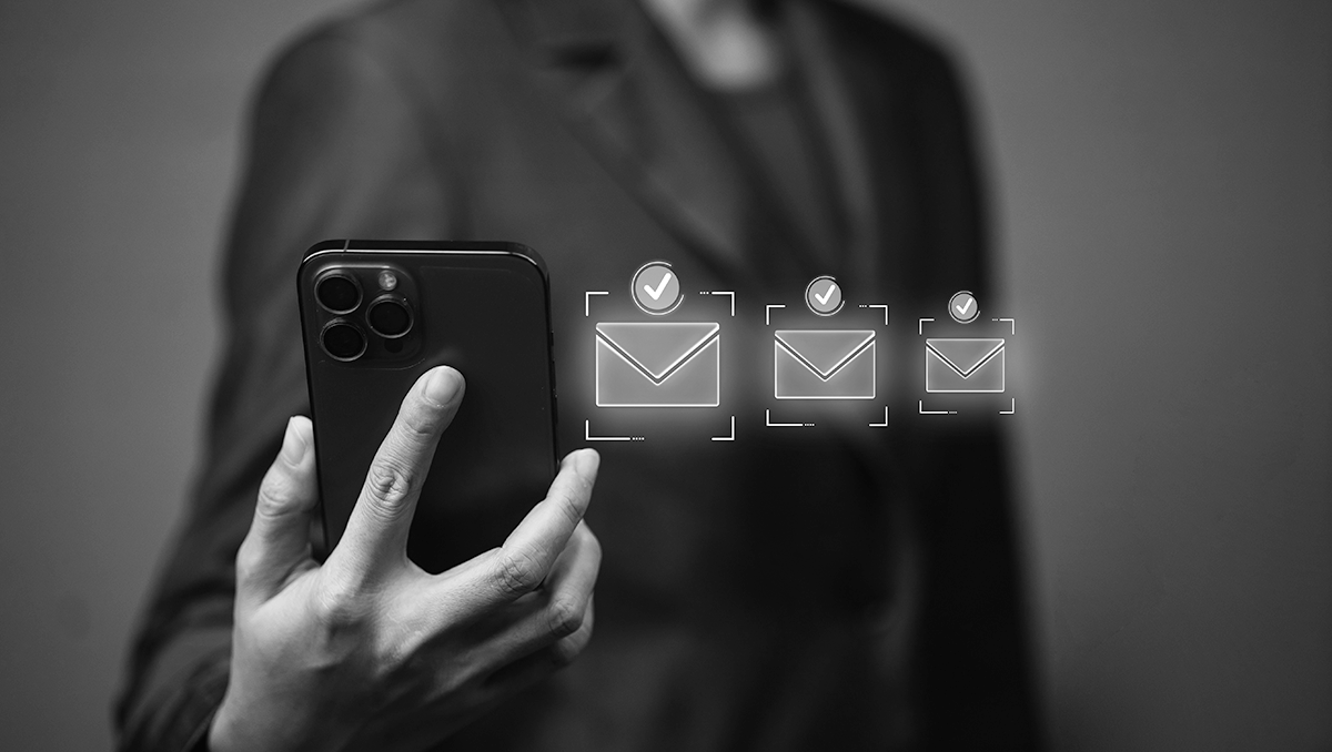 woman with a phone and three email envelopes