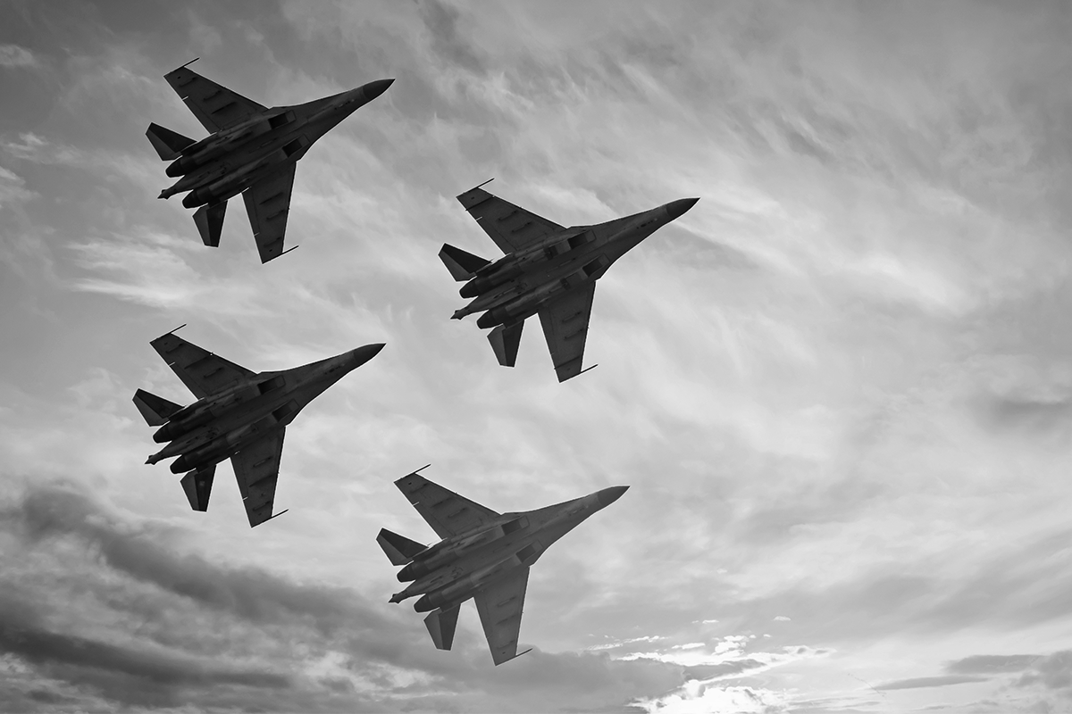 black and white photo of military jets in flight