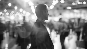 Image of business man in crowded room