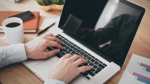 Security Employee typing on laptop